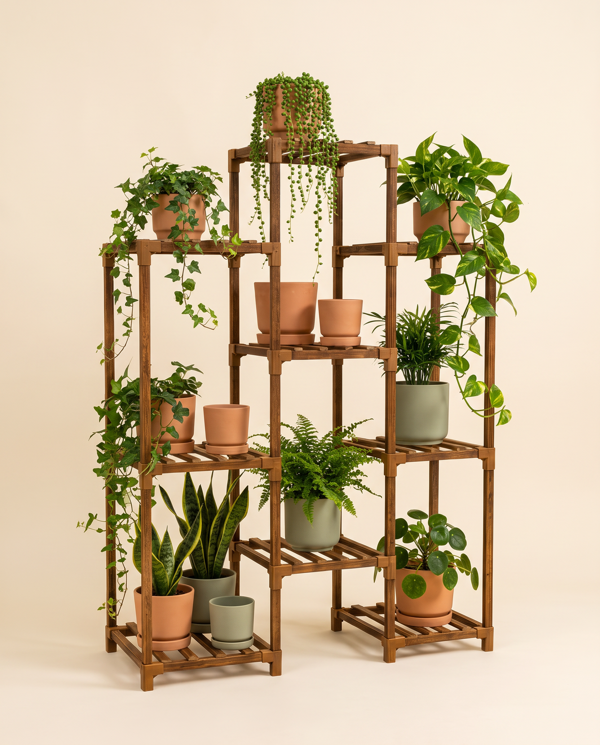 4-tier wooden boho plant stand with terracotta and sage ceramic pots, studio shot